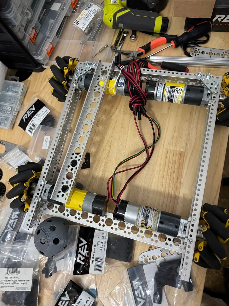 A robot chassis of aluminum rails and motors, mid-build.