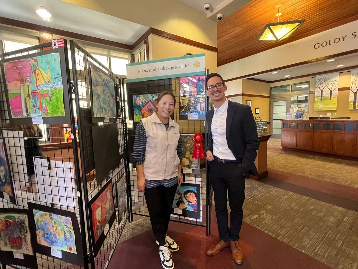 Two guests stand beside the panels at the exhibition entrance.