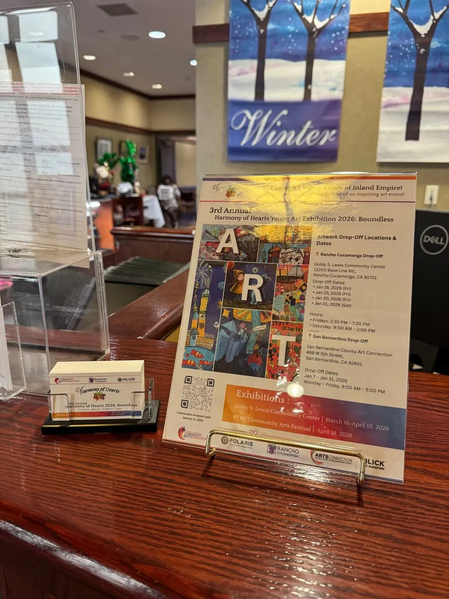 The exhibition flyer and a winter-themed painting on the front counter.